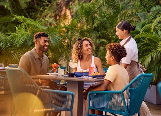 レストランのテラスで食事を楽しむ父、母、息子