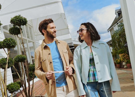 a Couple Walking Outdoors on a Sunny Day