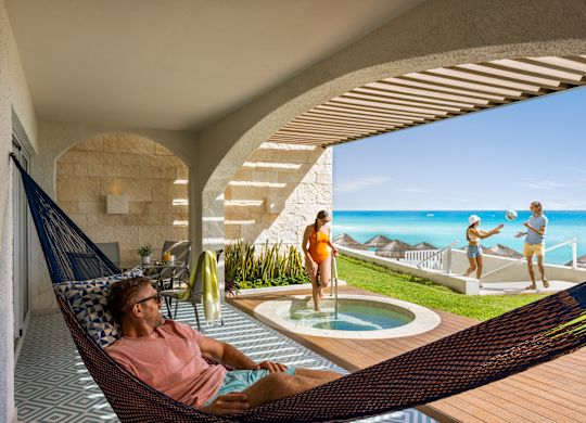 A suite patio with a hammock and hot tub.