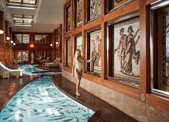 A woman enjoying a day in the pool area at the Elysion spa