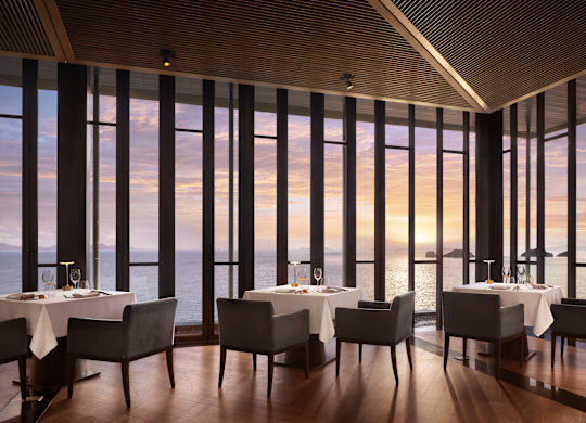 Área para refeições com vista para o mar ao pôr do sol no restaurante Jahn