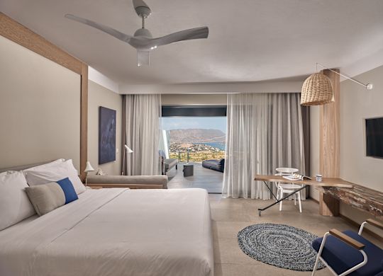 Sapphire Zen suite bedroom with queen bed and outdoor sharing pool