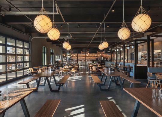 Spacious on-site brewery restaurant featuring ample seating and cozy atmosphere
