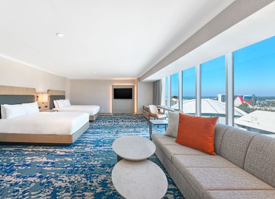 Guest Room with Two Beds, Television, Sofa and Large Windows