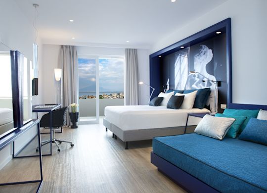Guestroom with Bed, Sofa, Work Desk and Outside View and Patio