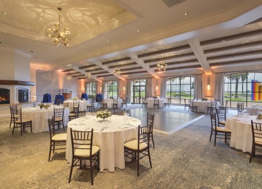 ballroom with round tables , dance floor, and fireplace