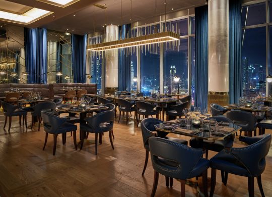 Bull & Bear seating with Dubai skyline at night