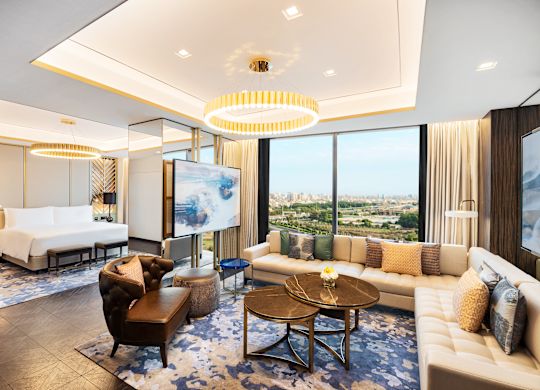 Presidential Suite Living Area and View of  Large Bed in Bedroom