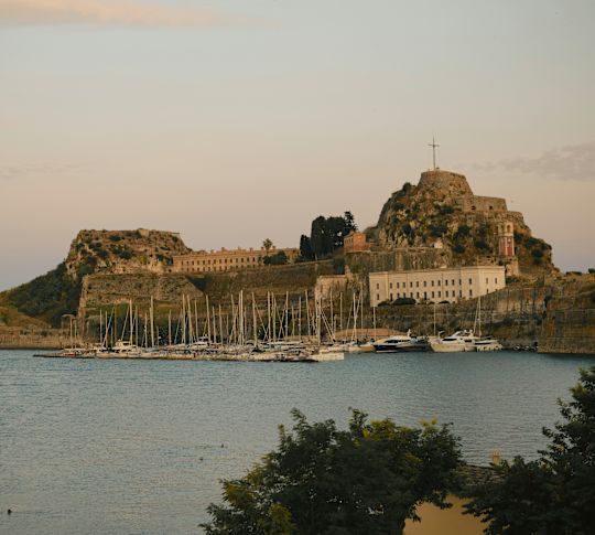 Marina and architecture built into the hills with a cross at the top are highlights on the footsteps of the Durrell family trail.