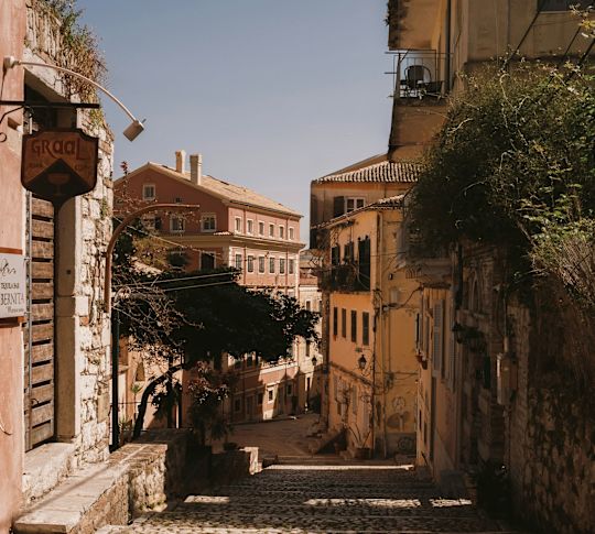 Old town with pebble walkways and traditional housing lining the path.