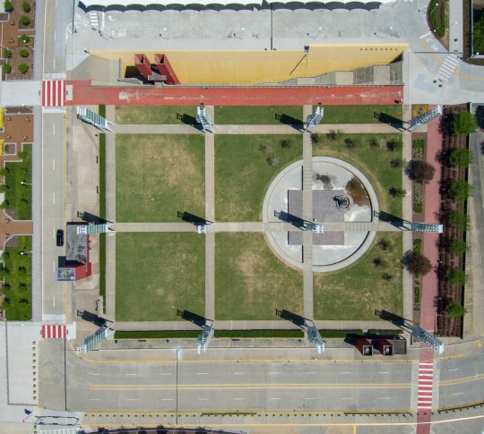 overhead aerial shot of Georgia International Plaza with green trees and grass outside of the Georgia World Congress Center in Atlanta Georgia USA