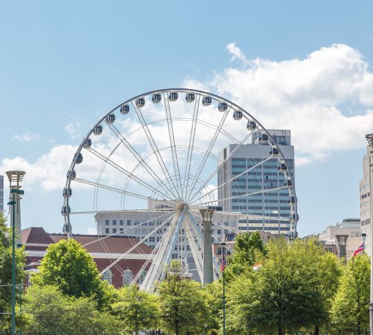 Ferris wheel in Atlanta with buildings in background