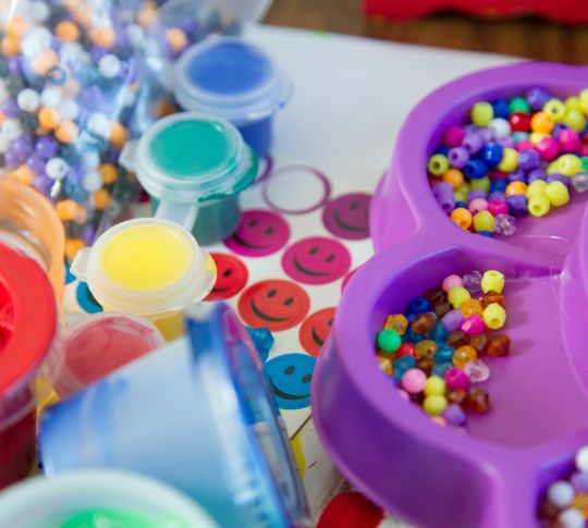 Bright-colored beads, paints, and stickers for kids