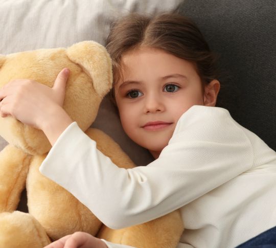 little girl holding teddy bear