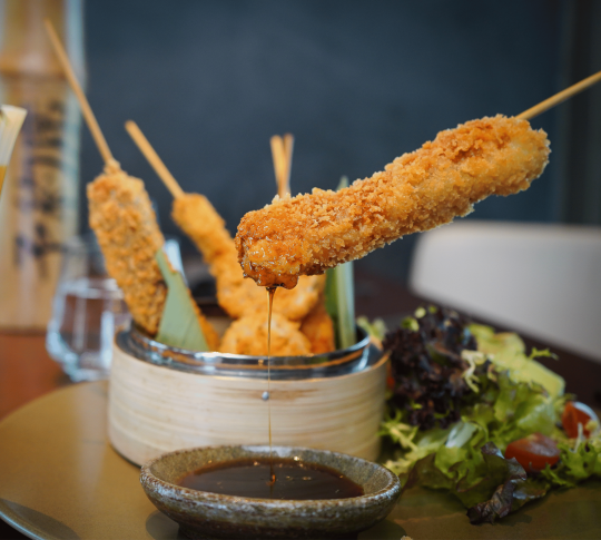 food being dipped into a sauce