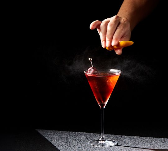 a Man Adding Last Tuches to a Cocktail Glass