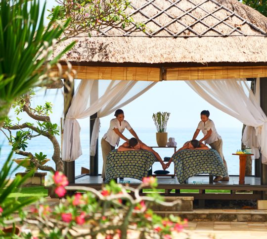 Couple on Massage Beds in Outdoor Spa Hut