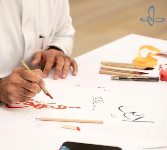 Man writing calligraphy at a hotel event.