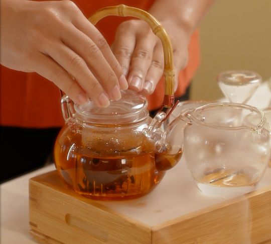 a person preparing tea at Golden Peony