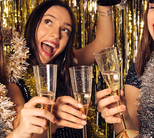 guest at a New Year's Eve party toasting with champagne