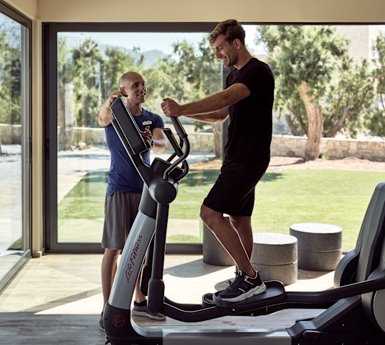 Man using an elliptical machine at the fitess center