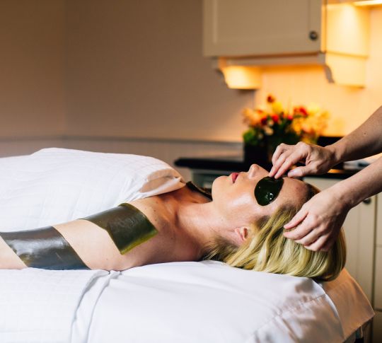Woman having a seaweed spa treatment