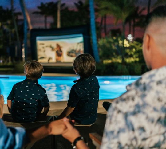 Family Watching Movie at Pool