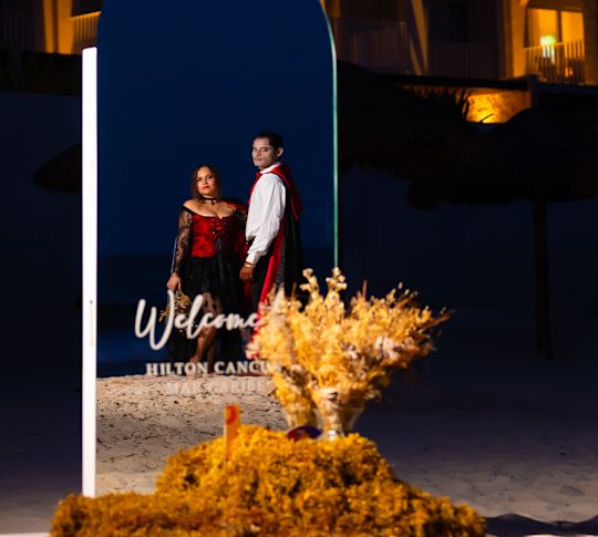 A Couple Is Dressed in Dracula Costume at the Entrance of Hilton Cancun to Celebrate Halloween