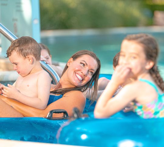 family floating on tubes in the lazy river at Jade Waters, water park