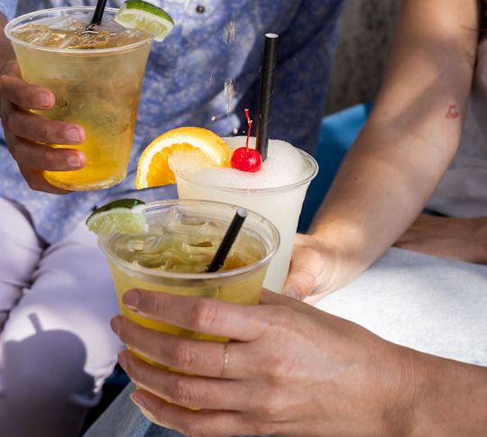 Women Enjoying Drinks while a Bartender Pours a Drink into a Glass-transition