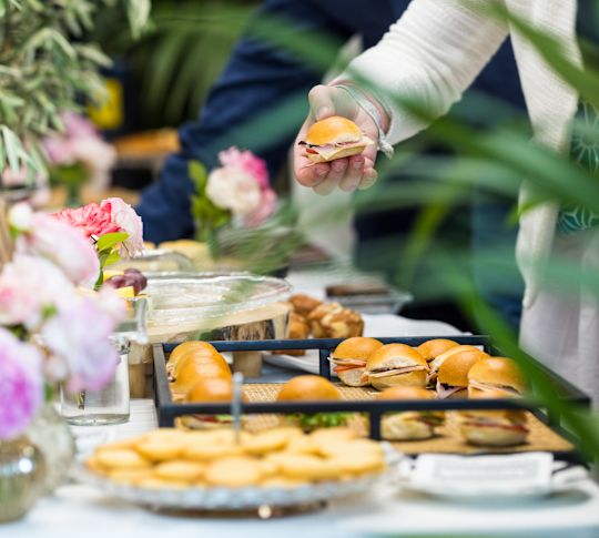 People Getting Sandwiches Served at a Banquet