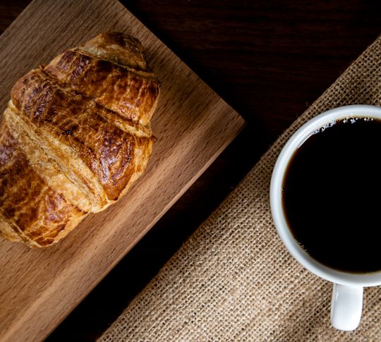 Croissant and Coffee on a Table