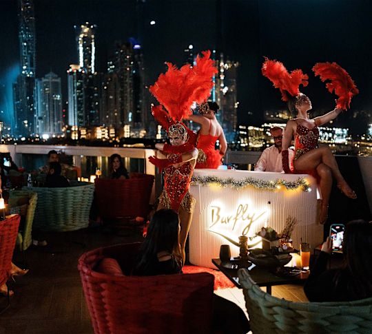 Barfly by Buddha-Bar outdoor cabaret performer along with people at tables