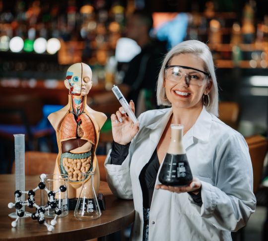 Mcg Quiz night woman dressed as scientist with beaker