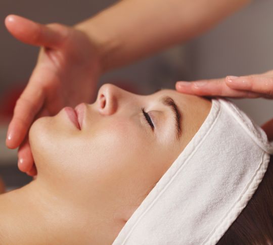 Woman receiving facial massage