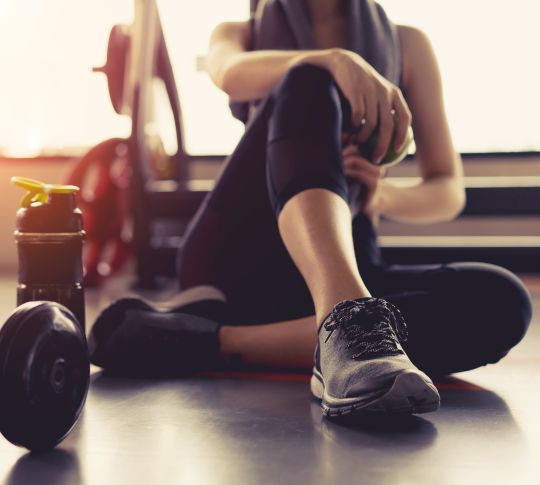 Person next to fitness weights
