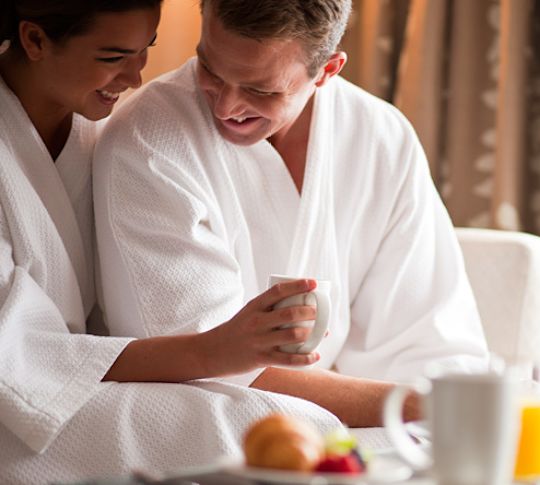 Couple Eating Breakfast in Bedroom