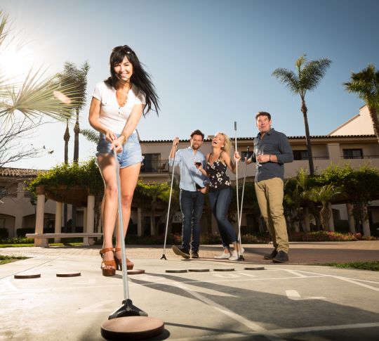 Group of friends playing shuffle board