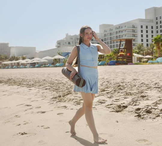 A Woman Walking at the Beach