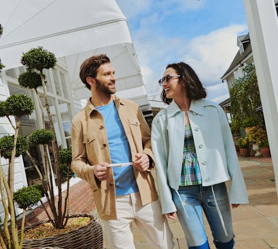 a Couple Walking Outdoors on a Sunny Day