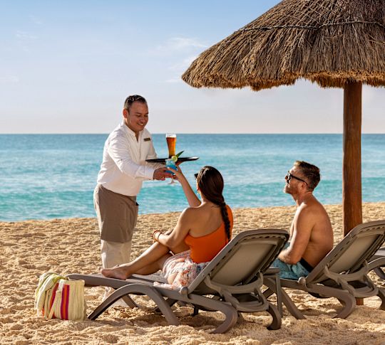 Couple having drinks on the beach.