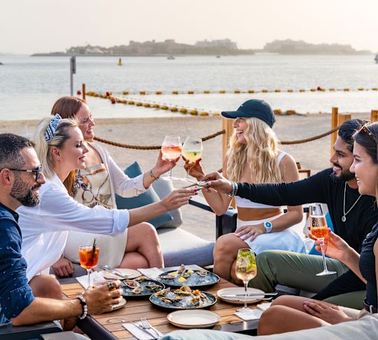 a Group of People Dining at Jones the Grocer Restaurant with Beach View