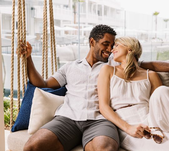 couple sitting on outdoor swing