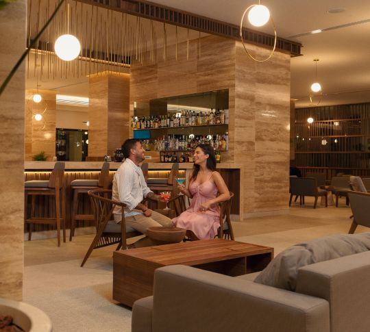 Man and woman relaxing in lobby bar area