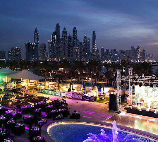 Aerial shot of pool and event seating at night