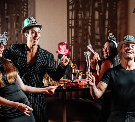 Trader Vic's people celebrating with themed hats