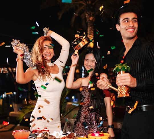 Tahitian Village people celebrating with drinks