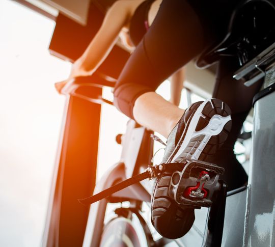 Woman on a stationary bike in the gym