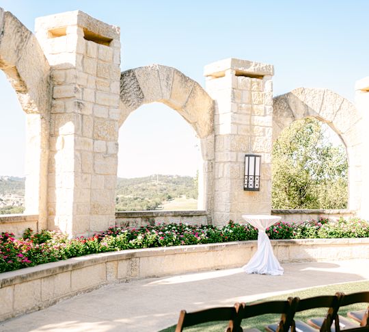 Standing Table in Patio Area with Stone Arches and a Flower Base-transition