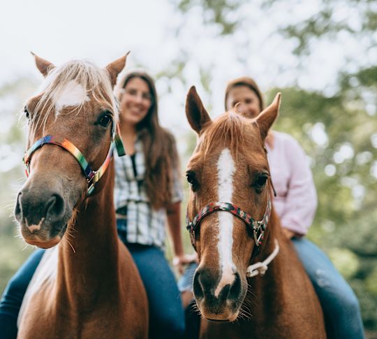 Two Women Riding Horses